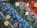 Colorful poker chips piled together with white-outlined circular markers and dice icons overlaid on top.